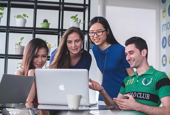 Colleagues collaborating over a laptop